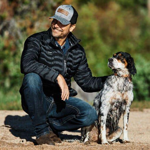 Man in Ariat jacket with a dog